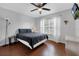 Relaxing bedroom showcasing a comfortable bed, ceiling fan, and rich wood floors at 8646 La Isla Dr, Kissimmee, FL 34747