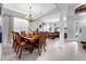 Open-concept dining room with a chandelier, neutral walls, and views of the living space at 8646 La Isla Dr, Kissimmee, FL 34747