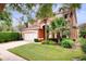 Two-story home with a two-car garage, palm trees, and a well-manicured lawn at 8646 La Isla Dr, Kissimmee, FL 34747