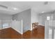 Upstairs hallway featuring wood flooring, railing, and a view of the entryway at 8646 La Isla Dr, Kissimmee, FL 34747