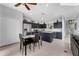 An open kitchen features stainless steel appliances, an island, and a dining table for a modern living experience at 8646 La Isla Dr, Kissimmee, FL 34747