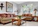 A cozy living room is adorned with plants, comfortable seating, and a view of the outdoors for a relaxing ambiance at 8646 La Isla Dr, Kissimmee, FL 34747
