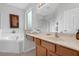 The bathroom features a garden tub, walk-in shower, double vanity, and lots of natural light at 8646 La Isla Dr, Kissimmee, FL 34747