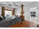Relax in a bedroom featuring hardwood floors, access to the pool, and a connected kitchen area at 8646 La Isla Dr, Kissimmee, FL 34747