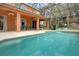 An inviting screened-in pool area with comfortable seating and an outdoor ceiling fan at 8646 La Isla Dr, Kissimmee, FL 34747