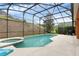 The screen-enclosed pool and patio area features jacuzzi and a lush garden bed at 8646 La Isla Dr, Kissimmee, FL 34747