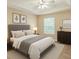 Comfortable bedroom with tray ceiling, neutral walls, and natural light from the window at 1 Pecan Course Cir, Ocala, FL 34472