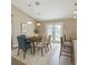 Dining room with modern table set, bar stool seating, and sliding glass doors to the backyard at 1 Pecan Course Cir, Ocala, FL 34472