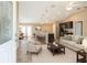 Open concept living room and kitchen featuring modern furnishings and neutral color palette at 1 Pecan Course Cir, Ocala, FL 34472