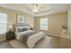 Charming main bedroom with tray ceiling, ceiling fan, and natural light from two windows at 1 Pecan Course Cir, Ocala, FL 34472