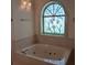 Bathroom area featuring an arched stain glass window over a soaking tub at 19811 Lake Dorr Rd, Altoona, FL 32702