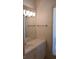 Bathroom vanity featuring a mirror, white cabinetry, and window with plantation shutters at 19811 Lake Dorr Rd, Altoona, FL 32702