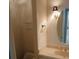 This bathroom offers a vanity with decorative lighting, oval mirror, and granite countertop at 19811 Lake Dorr Rd, Altoona, FL 32702