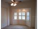 This bedroom features neutral walls and carpet with a ceiling fan and large window providing plenty of natural light at 19811 Lake Dorr Rd, Altoona, FL 32702
