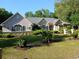 Lovely single-story home boasting manicured lawn and lush tropical landscaping at 19811 Lake Dorr Rd, Altoona, FL 32702
