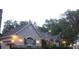 Dusk view of home and garage featuring manicured lawn and mature trees at 19811 Lake Dorr Rd, Altoona, FL 32702