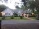 Charming single-story home featuring manicured landscaping and mature trees at 19811 Lake Dorr Rd, Altoona, FL 32702