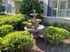 Beautiful fountain surrounded by lush green bushes adds charm to the home's exterior at 19811 Lake Dorr Rd, Altoona, FL 32702