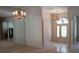 Foyer with tile flooring, mirrored wall, and front door with stained glass transom at 19811 Lake Dorr Rd, Altoona, FL 32702