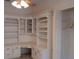 Office featuring built-in bookshelves, white cabinetry, and a ceiling fan at 19811 Lake Dorr Rd, Altoona, FL 32702