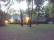 Exterior view of home among trees with expansive wooded and shaded lawn at 19811 Lake Dorr Rd, Altoona, FL 32702