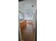 Bathroom featuring wood cabinets, granite countertops, wood floors, and soaker tub at 1524 New Jersey Oaks Ct, Lakeland, FL 33801