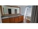 Bright bathroom featuring a double vanity with granite counters and a soaking tub with modern fixtures at 1524 New Jersey Oaks Ct, Lakeland, FL 33801