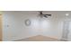 Bedroom with light-colored walls, neutral carpet, modern light fixtures, and a door to the backyard at 1524 New Jersey Oaks Ct, Lakeland, FL 33801