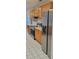 Modern kitchen with stainless steel appliances, light wood cabinets, and granite countertops at 1524 New Jersey Oaks Ct, Lakeland, FL 33801