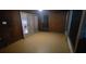 Spacious enclosed porch with wood paneled walls and neutral tile floor at 1524 New Jersey Oaks Ct, Lakeland, FL 33801