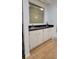Stylish wet bar featuring black countertop and wooden cabinets at 1524 New Jersey Oaks Ct, Lakeland, FL 33801