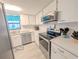 Well-maintained kitchen with modern appliances, white cabinets, and a bright, clean design at 3100 Ocean Shore Blvd # 101, Ormond Beach, FL 32176
