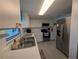 Bright kitchen with white cabinets, stainless steel appliances and light countertops at 3100 Ocean Shore Blvd # 101, Ormond Beach, FL 32176
