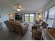 Living room with sliding glass doors to the outdoor, ceiling fan and comfortable furniture at 3100 Ocean Shore Blvd # 101, Ormond Beach, FL 32176