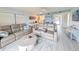 Cozy living room with leather sofas, nautical decor, and views into the kitchen at 3100 Ocean Shore Blvd # 101, Ormond Beach, FL 32176