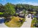 Aerial view of the home with a long driveway and mature trees at 4346 Thomas Wood Ln E, Winter Haven, FL 33880