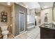 Bathroom area with enclosed glass shower and sunken tub at 4346 Thomas Wood Ln E, Winter Haven, FL 33880