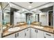 Bathroom featuring double sinks, granite countertops, and decorative mirrors at 4346 Thomas Wood Ln E, Winter Haven, FL 33880