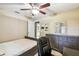 Bedroom with tile flooring and ceiling fan with a desk setup for home office at 4346 Thomas Wood Ln E, Winter Haven, FL 33880