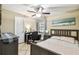 Bedroom featuring tile floors, ceiling fan and beach-themed decor at 4346 Thomas Wood Ln E, Winter Haven, FL 33880