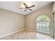 Bonus room featuring tile floors, a ceiling fan and large arched window at 4346 Thomas Wood Ln E, Winter Haven, FL 33880