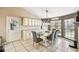 Bright dining area featuring a chandelier, large windows, and built-in cabinetry with granite countertops at 4346 Thomas Wood Ln E, Winter Haven, FL 33880