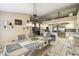 Bright, open dining area adjacent to kitchen with tile floors, modern table and view into kitchen at 4346 Thomas Wood Ln E, Winter Haven, FL 33880