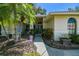 Inviting front entrance with blue door, lush landscaping, and decorative walkway at 4346 Thomas Wood Ln E, Winter Haven, FL 33880