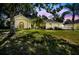 Lovely exterior view of home with arched windows, palm trees and well maintained lawn at 4346 Thomas Wood Ln E, Winter Haven, FL 33880