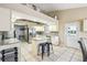 Kitchen with white cabinets, a center island, and stainless steel appliances at 4346 Thomas Wood Ln E, Winter Haven, FL 33880