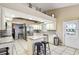Bright kitchen features stainless appliances, granite counters, white cabinets, and convenient island seating at 4346 Thomas Wood Ln E, Winter Haven, FL 33880