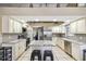 Spacious kitchen featuring granite counters, white cabinets, stainless appliances, and tile floors at 4346 Thomas Wood Ln E, Winter Haven, FL 33880