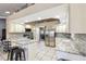 Bright kitchen with stainless steel appliances, white cabinets, granite countertops, and convenient island at 4346 Thomas Wood Ln E, Winter Haven, FL 33880