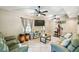 Relaxing living room featuring tile floors, multiple ceiling fans, comfortable seating and gym equipment at 4346 Thomas Wood Ln E, Winter Haven, FL 33880